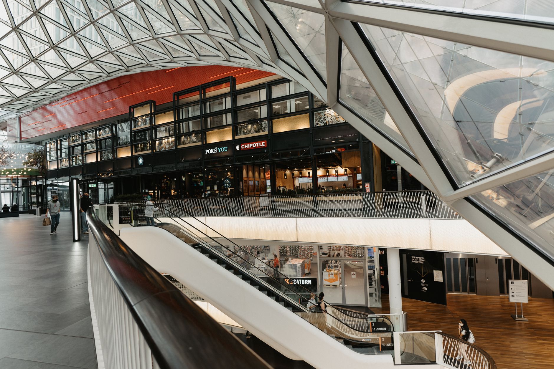 Nearly empty shopping mall corridor with few visible shoppers