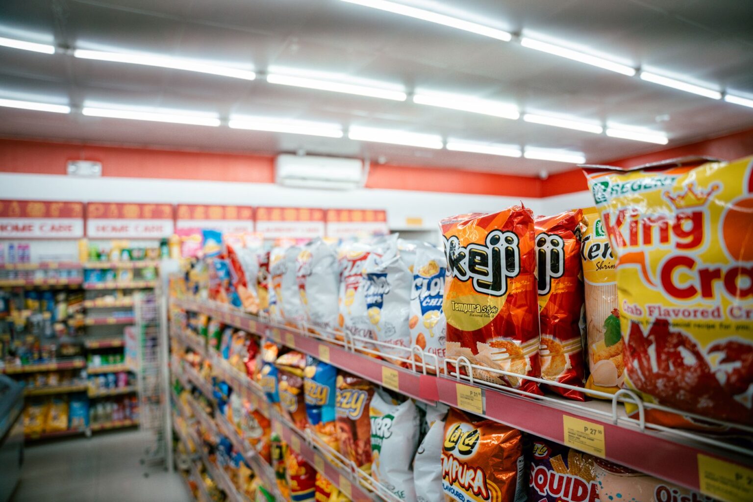 Snap Benefits Face Fresh Cuts as DOGE Targets USDA Spending Grocery store aisle with food products representing SNAP benefit purchasing