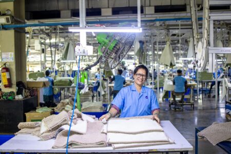 Workers sorting mail inside a postal sorting facility