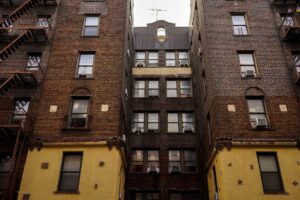 Federal Rental Assistance Backlog Swells as Eviction Filings Climb Exterior of a multi-unit residential rental building representing housing instability