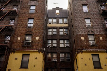 Federal Rental Assistance Backlog Swells as Eviction Filings Climb Exterior of a multi-unit residential rental building representing housing instability