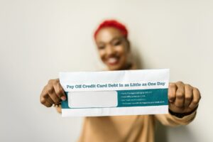 Credit Card Delinquency Rates Climb as Minimum Payment Traps Deepen Person holding a credit card while reviewing a bill at a desk