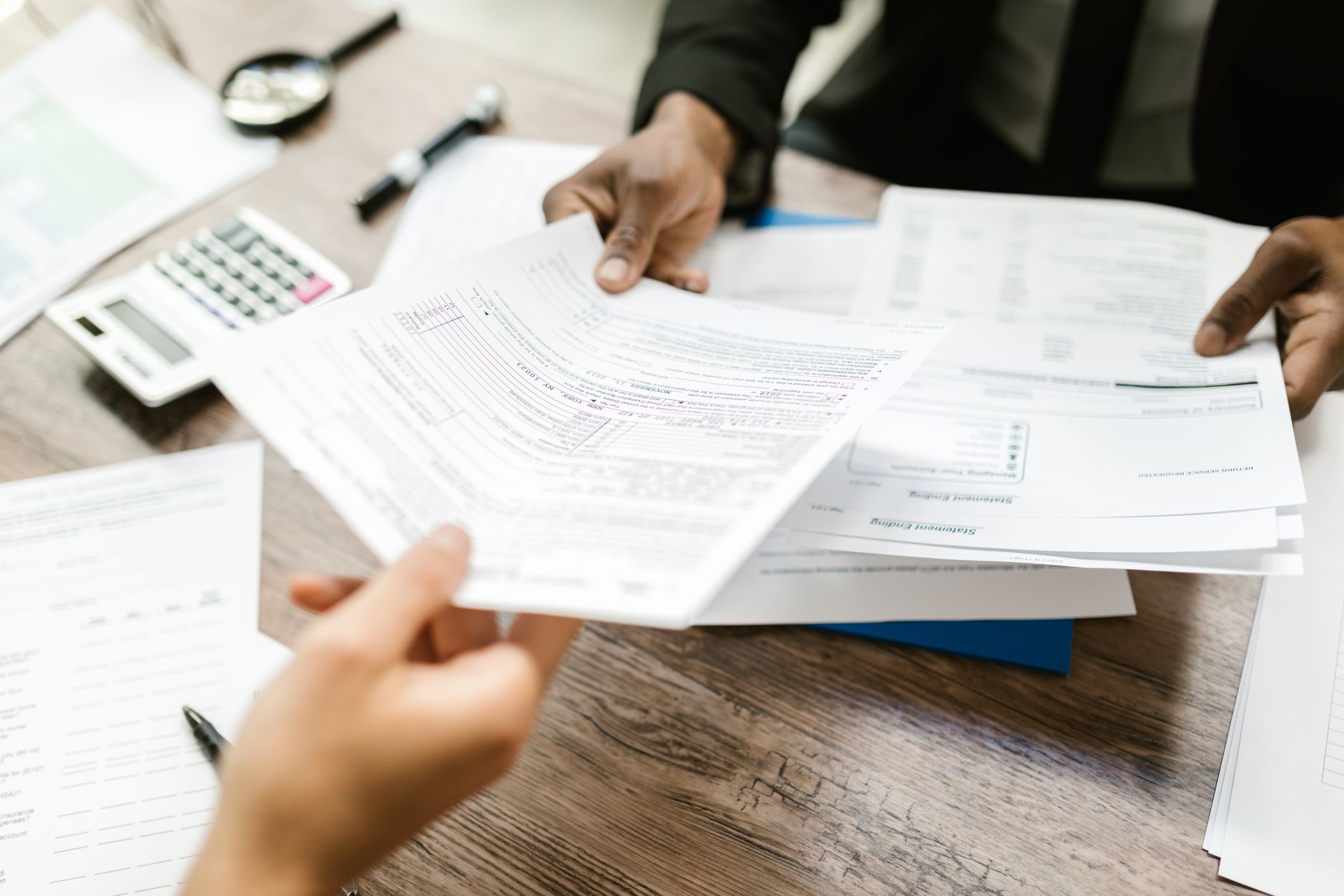 A family reviewing tax documents at a kitchen table