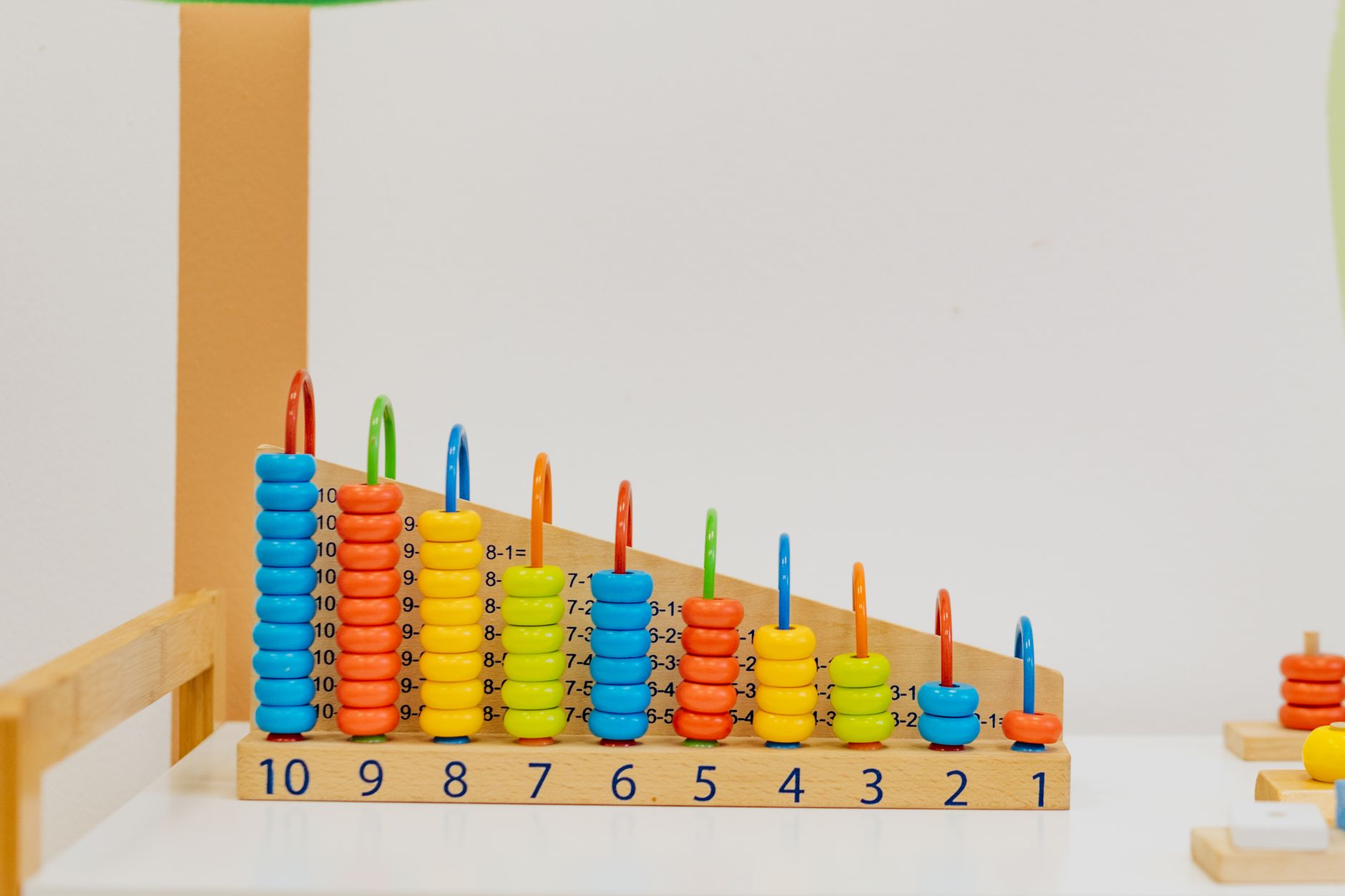 Childcare workers supervising young children in a licensed daycare classroom setting