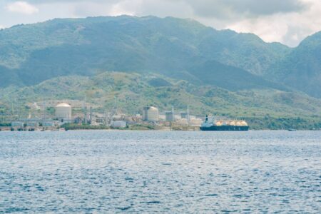 Natural Gas Export Boom Strains Domestic Grid Reliability Pledges Liquefied natural gas export terminal along a coastal waterway at dusk