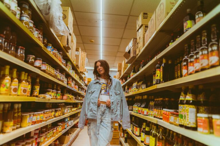 Consumer browsing product shelves in a grocery store aisle