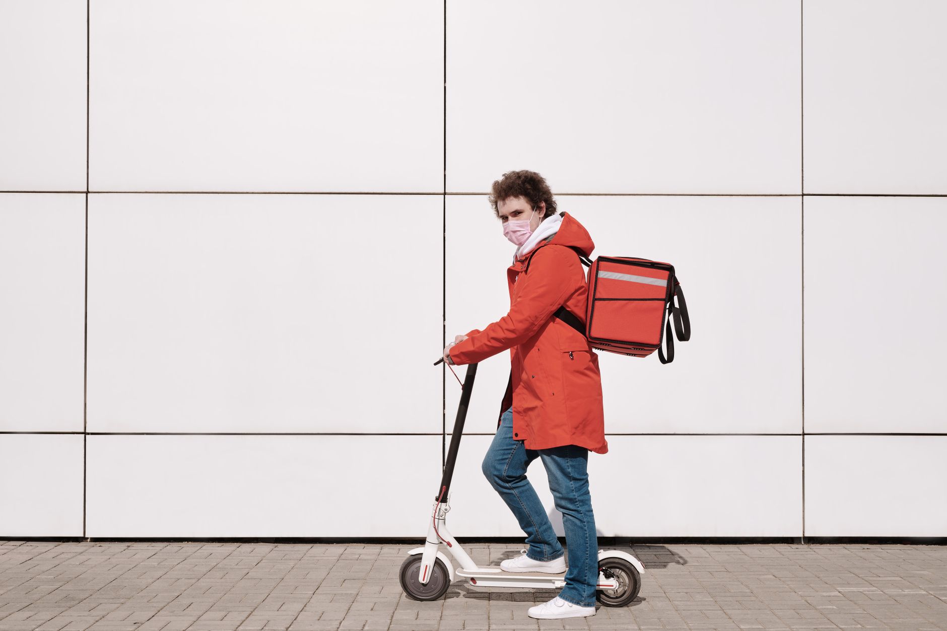 A gig worker on a bicycle delivering goods in an urban setting