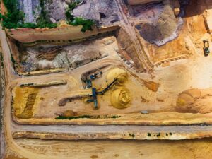 Open-pit lithium mining operation with heavy machinery and excavated terrain