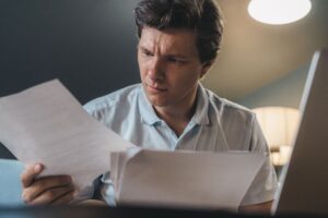 College student reviewing financial aid documents at a desk