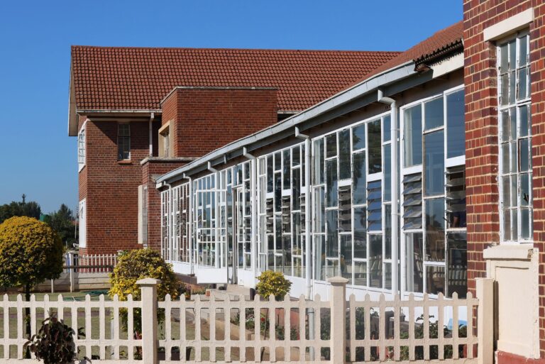 School District Budget Cuts Deepen as Property Tax Appeals Surge Exterior of a public school building on a quiet street