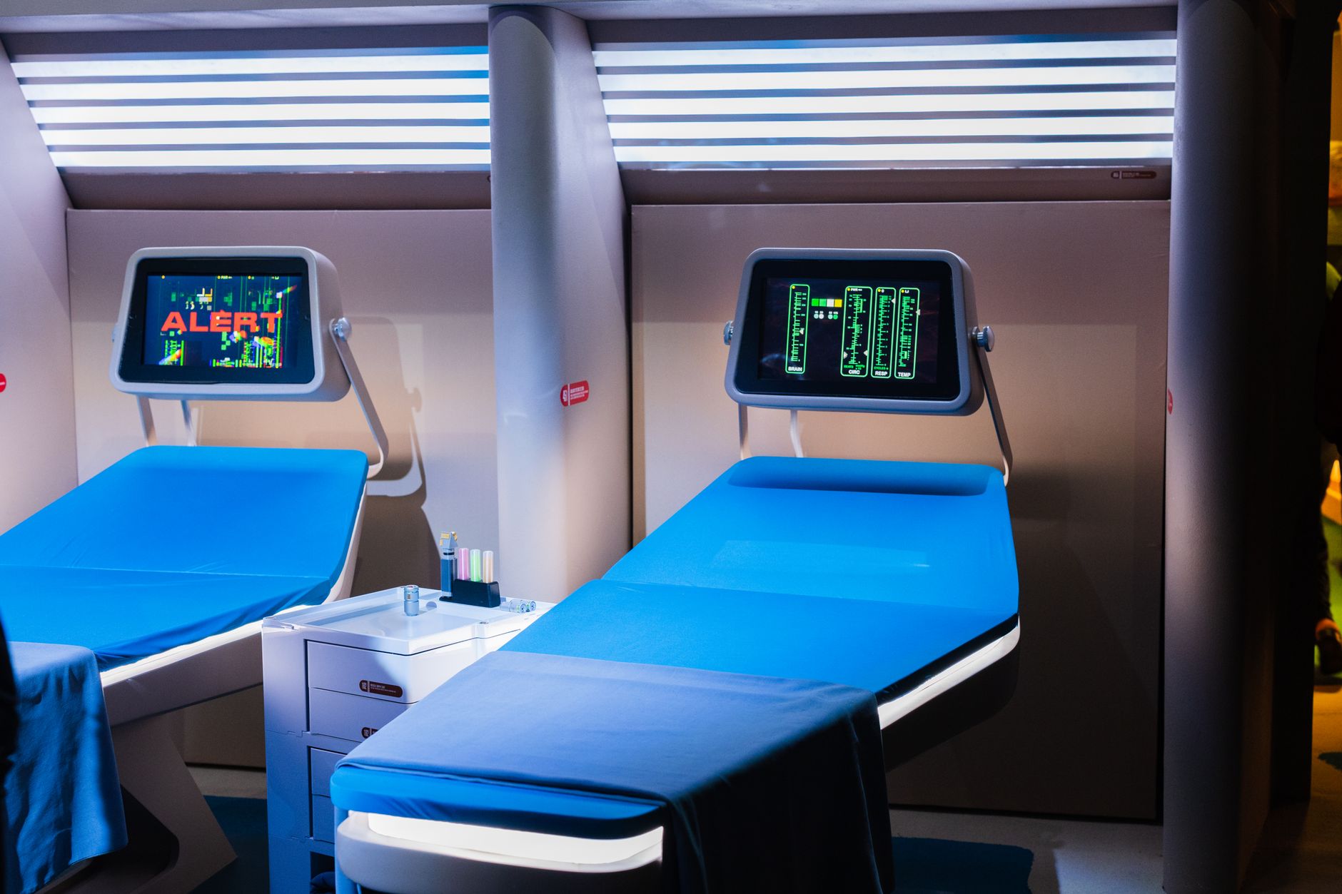 Empty hospital ward with unoccupied beds and medical equipment