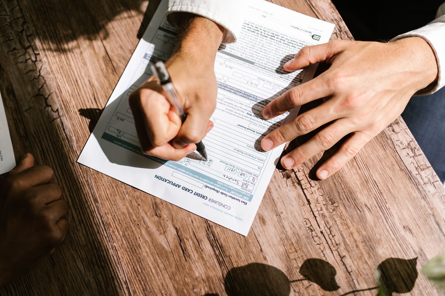 Auto loan paperwork and financial documents spread across a desk