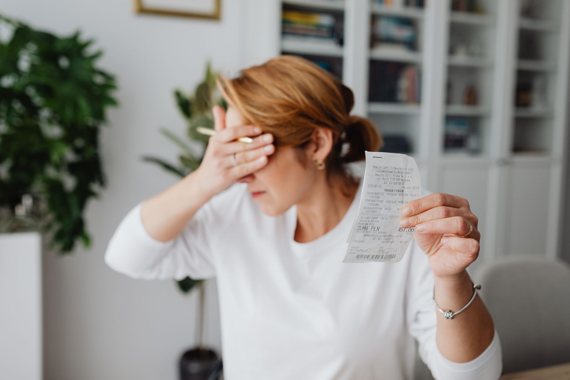 Parents looking stressed while reviewing household budget paperwork