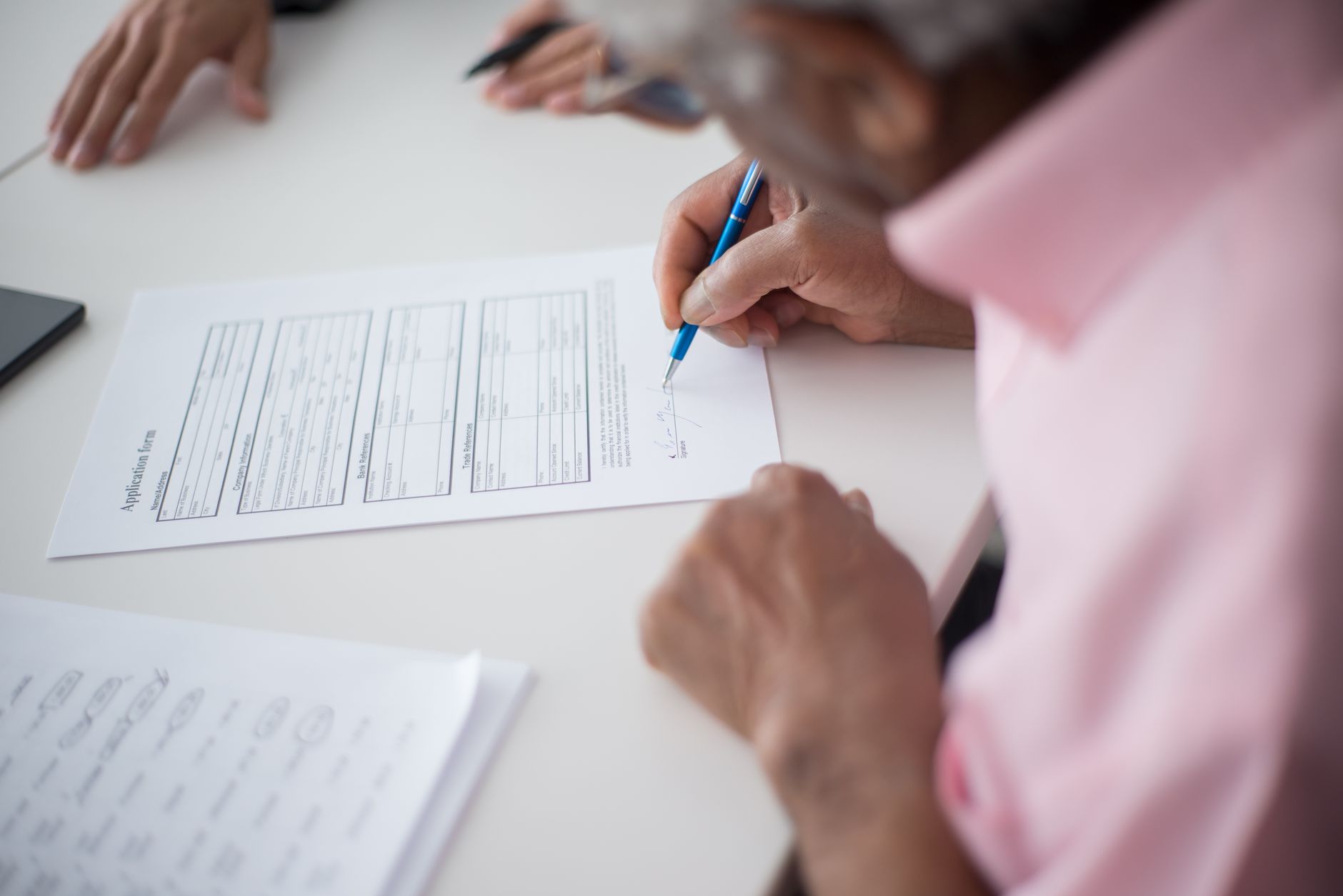 Person reviewing insurance documents at a desk
