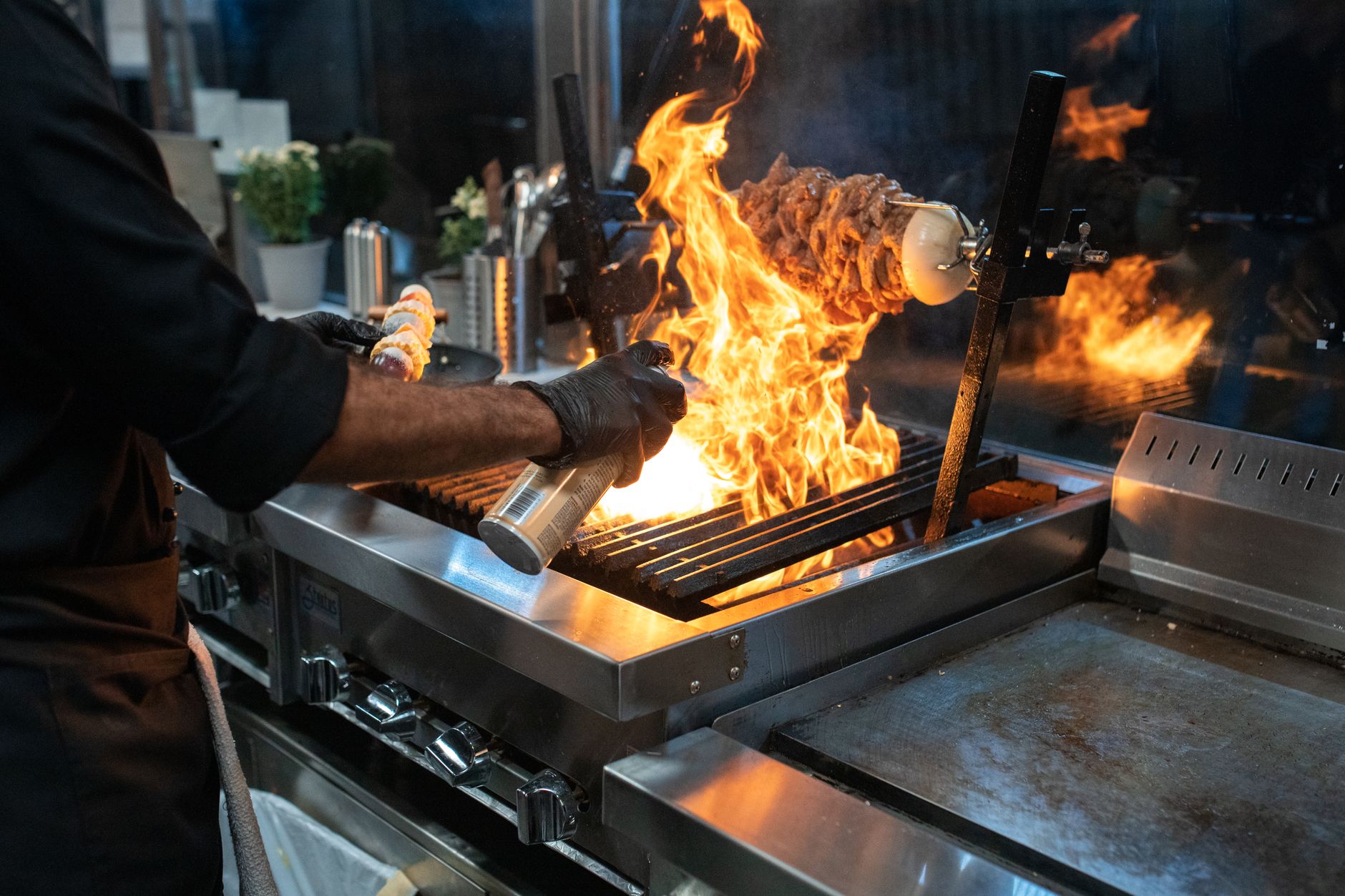 Commercial kitchen with cooks preparing food during a busy service