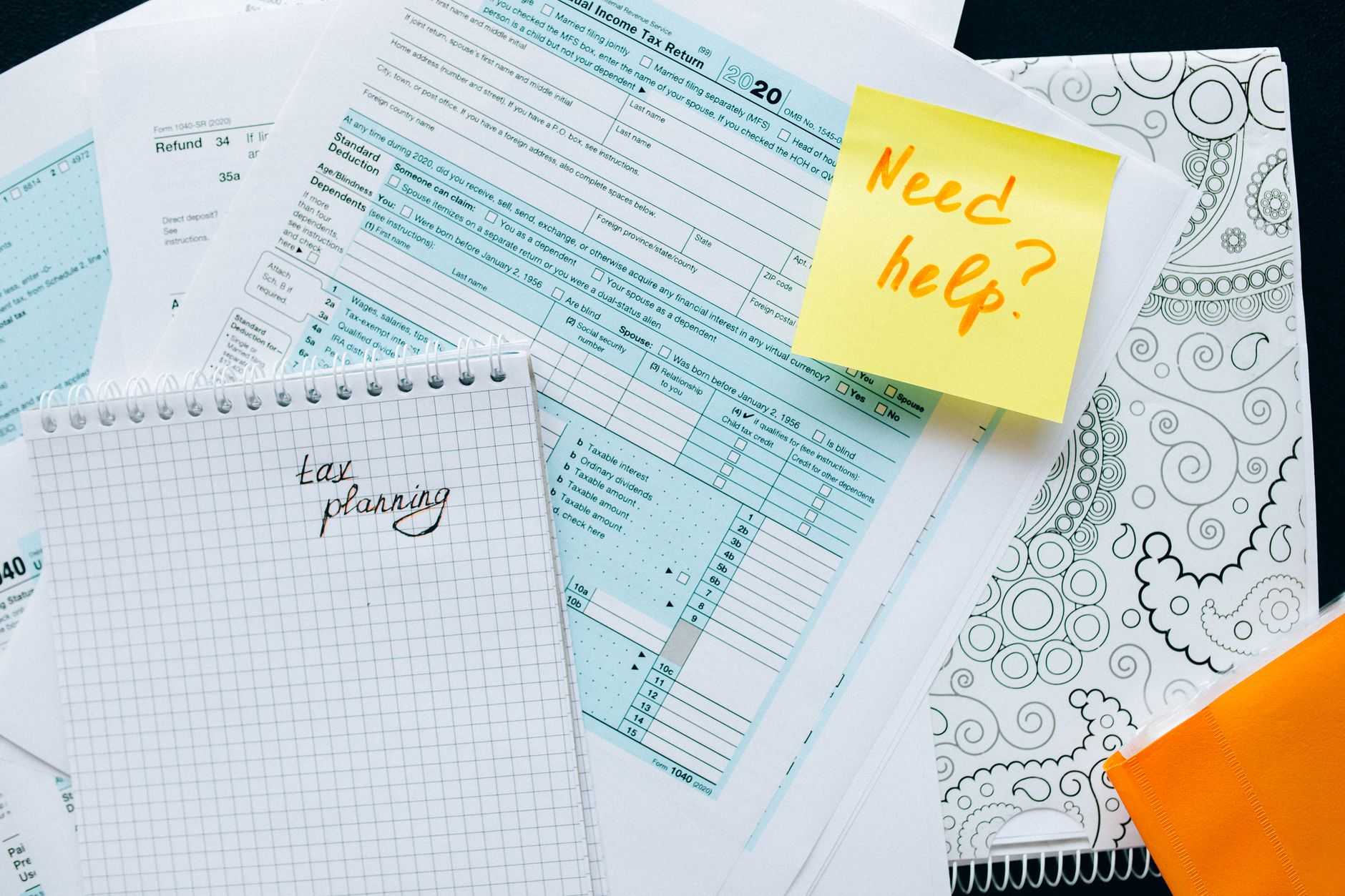 Government financial documents and budget reports spread across a table