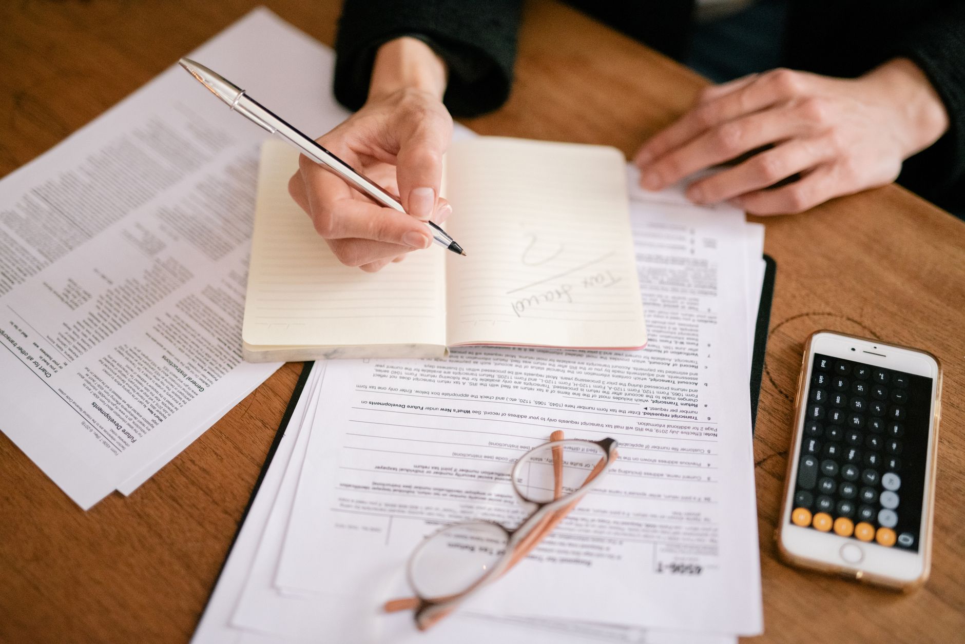 Tax forms and financial documents spread across a work desk