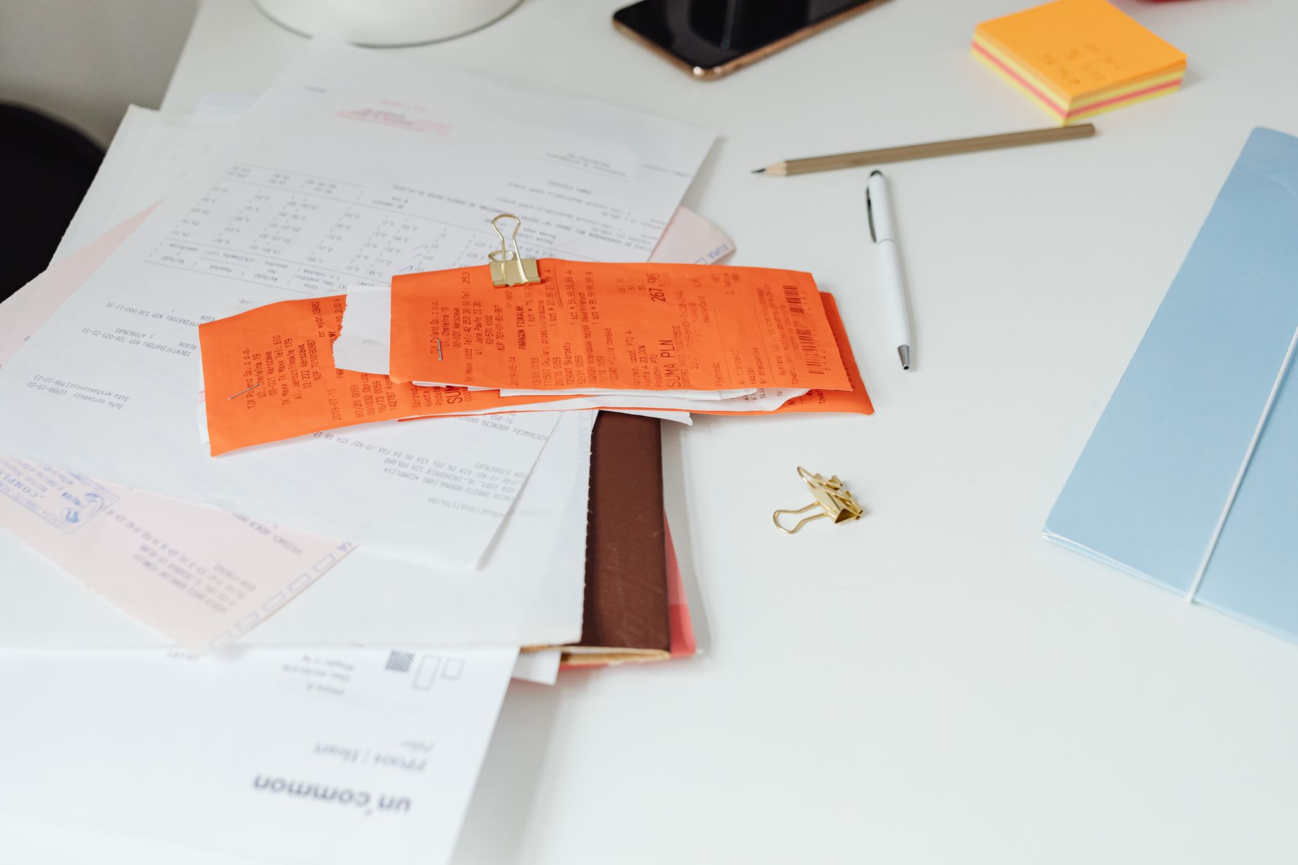 Person reviewing property expenses and financial paperwork at a desk