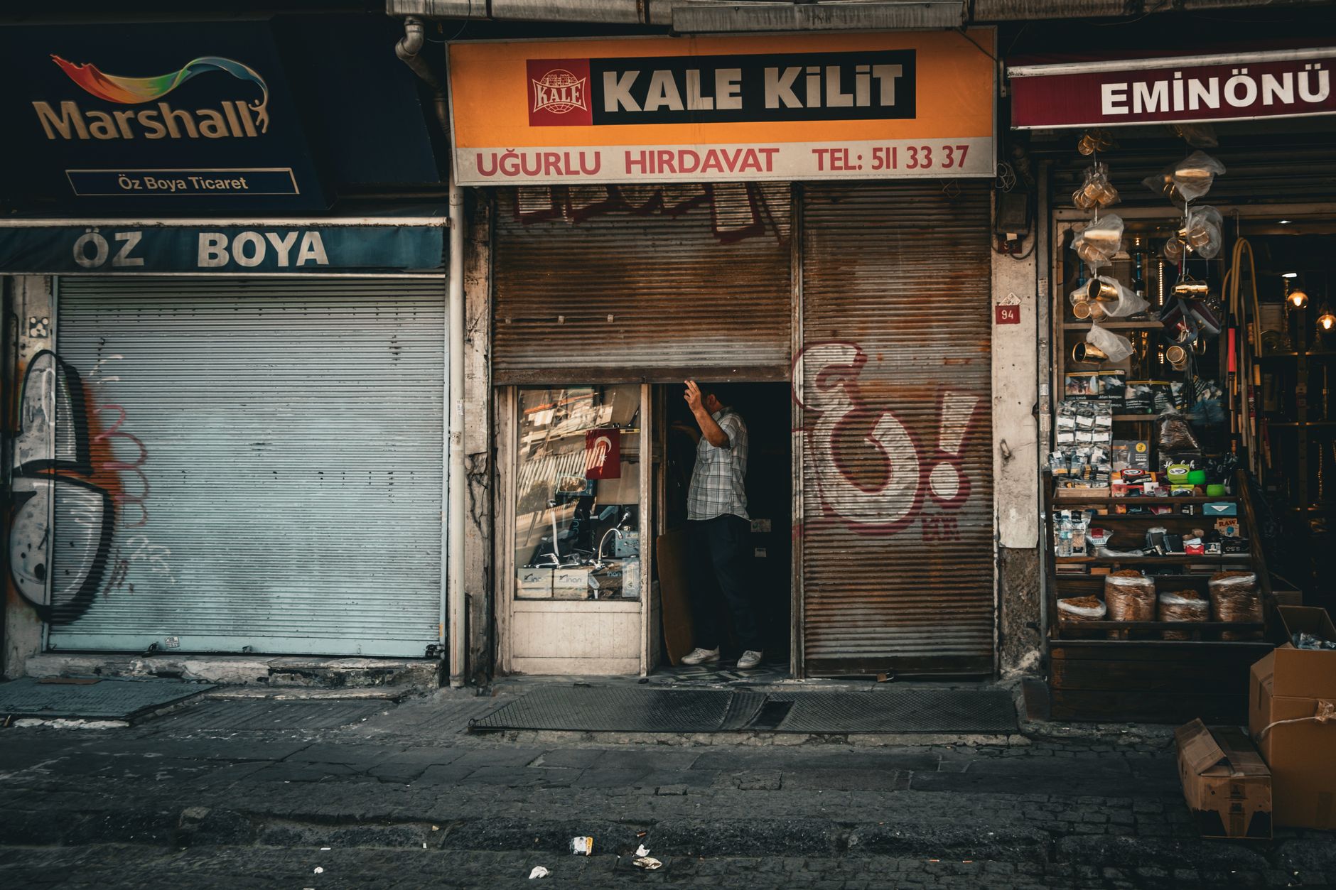 Quiet retail storefront with minimal customer activity on a city street