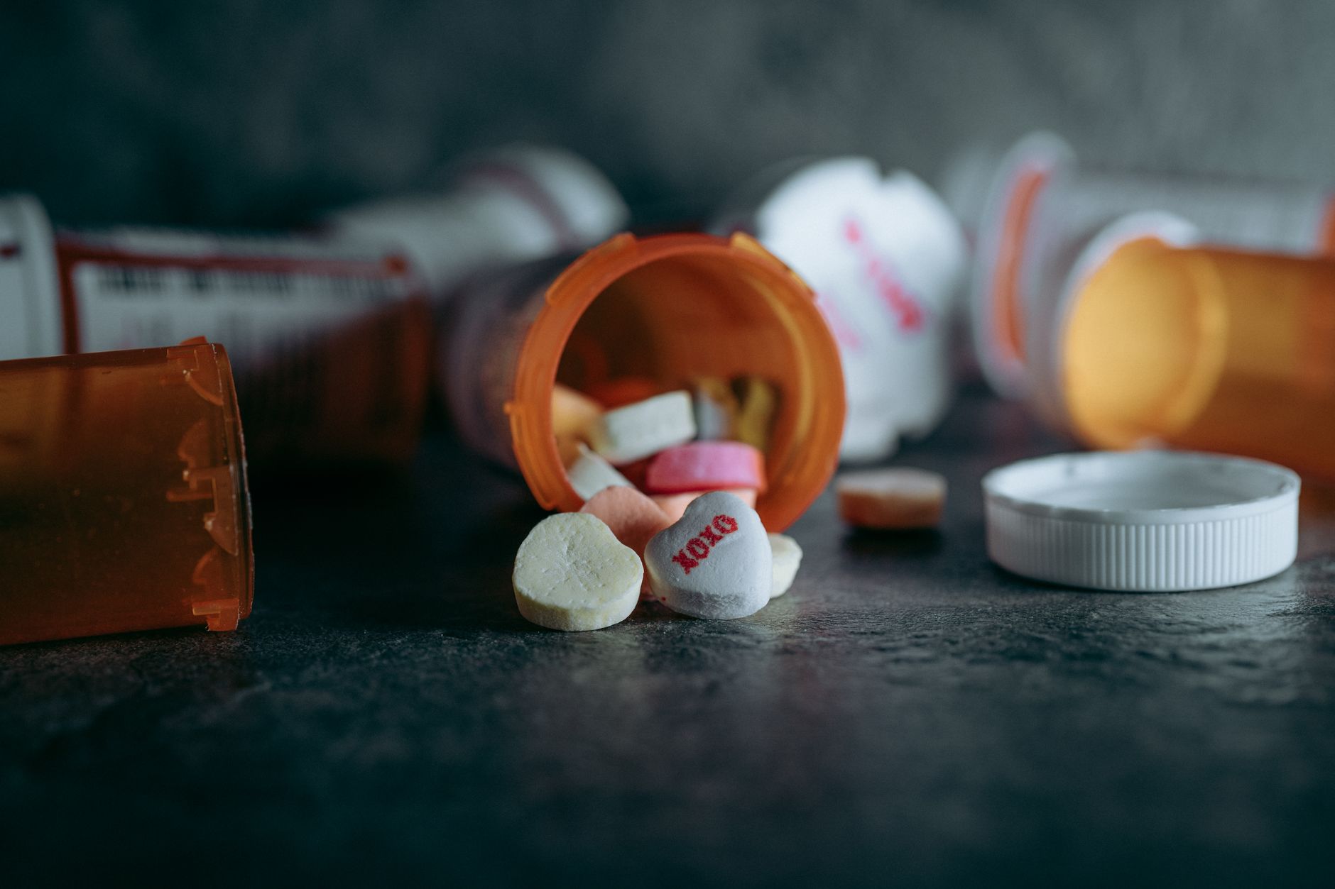 Prescription medication bottles on a pharmacy counter