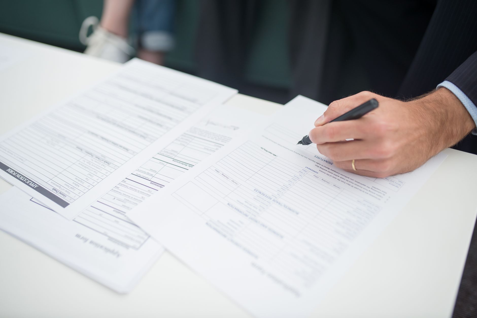 Farmer reviewing paperwork related to crop insurance claims at a desk