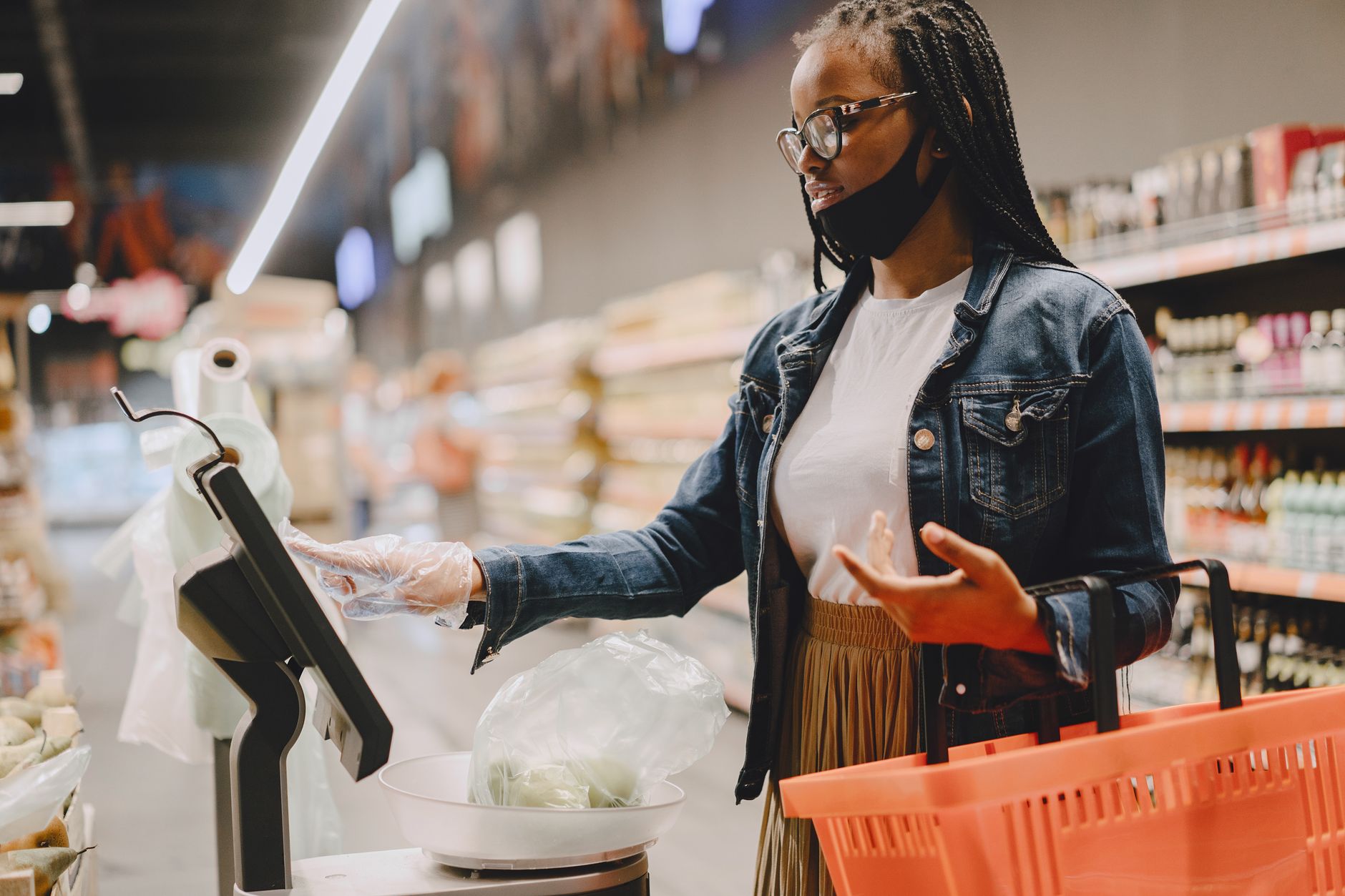 A customer reviewing grocery items at a supermarket checkout counter