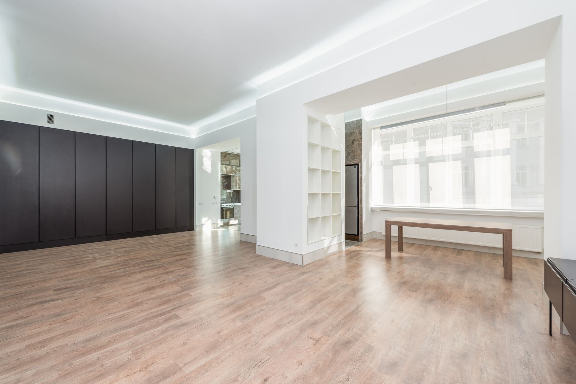 Sparse living room interior suggesting financial hardship in a household