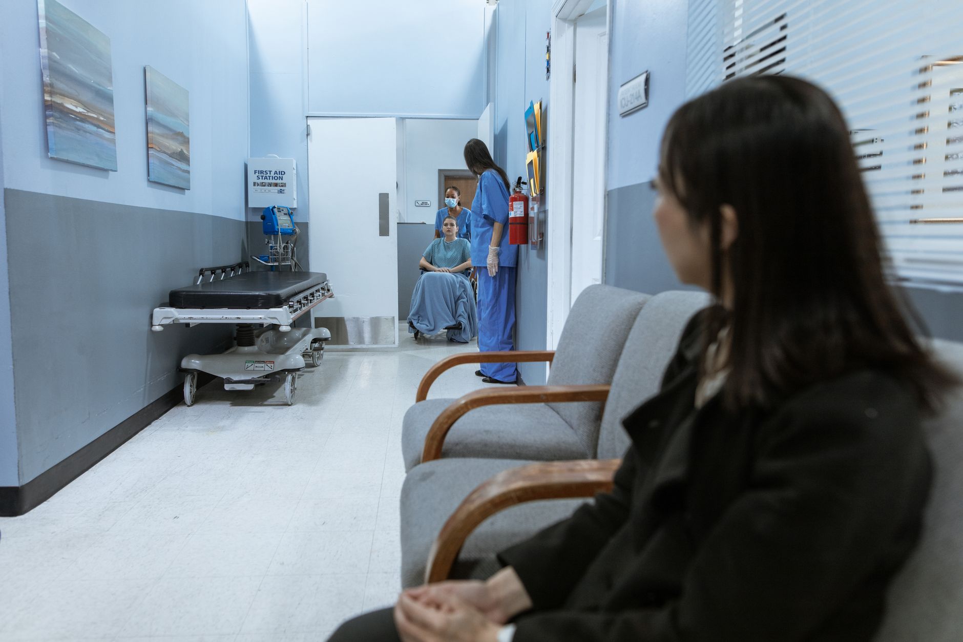 Patient sitting in hospital waiting area facing healthcare financial decisions