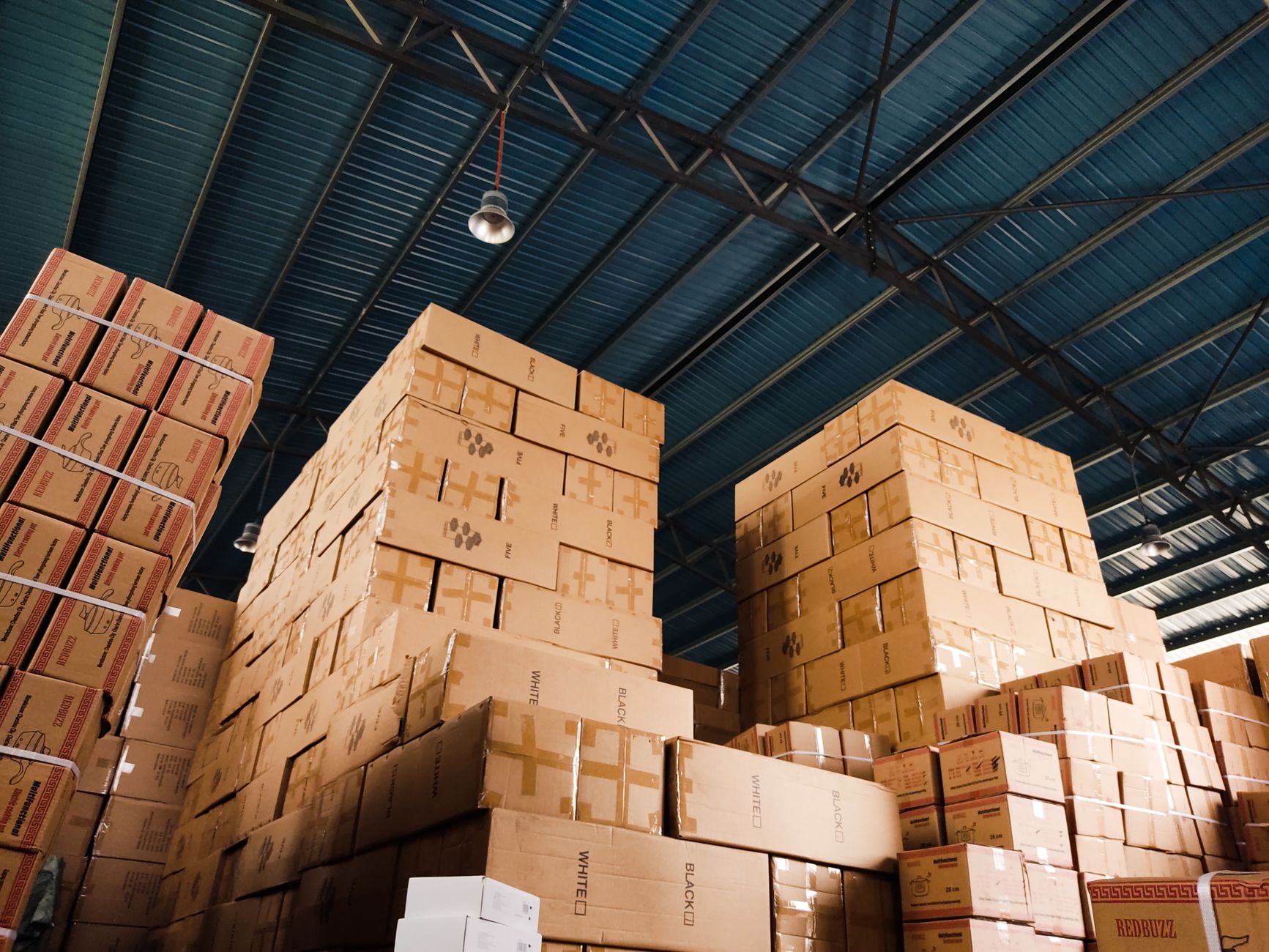 Interior of a large warehouse with pallets and forklift equipment
