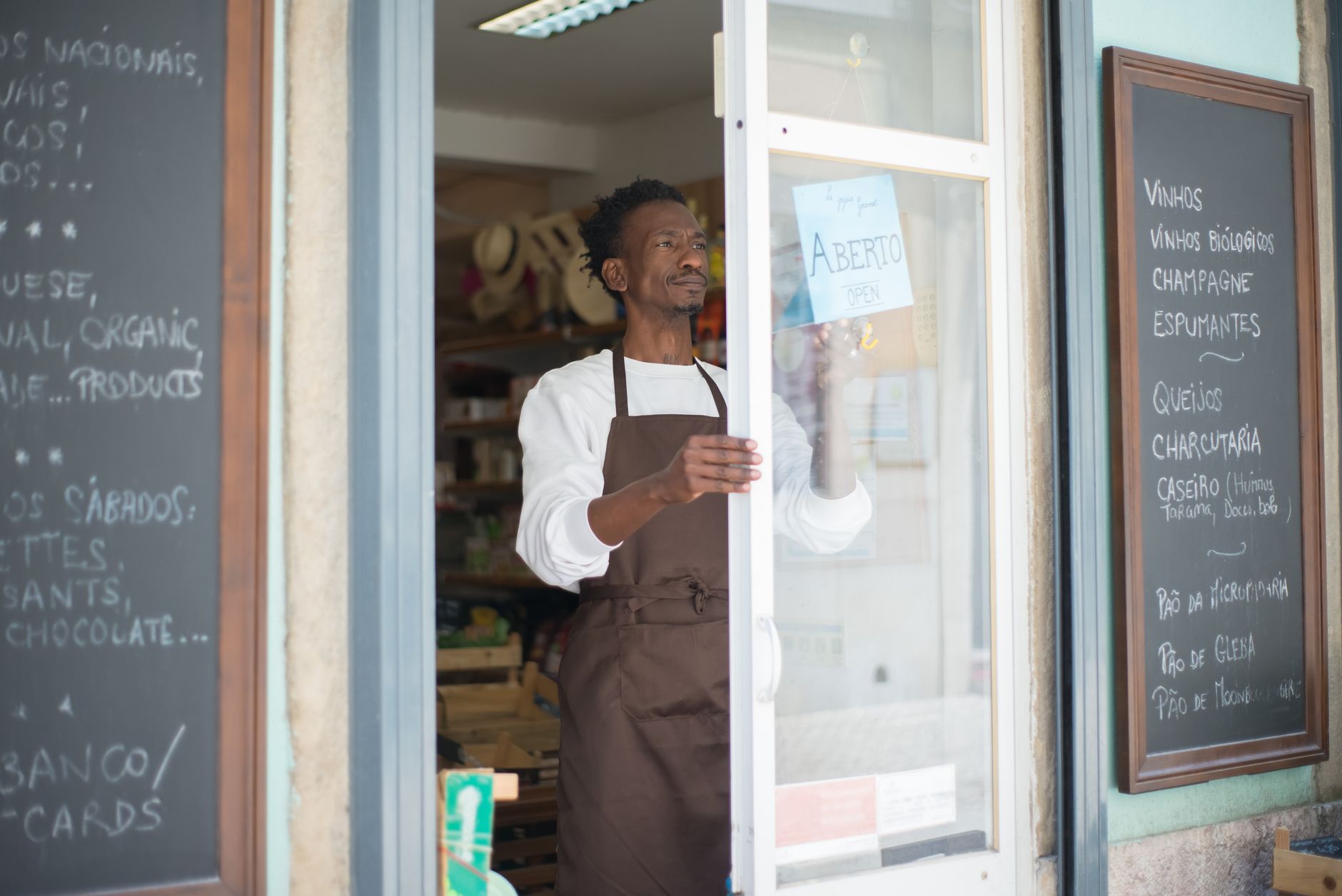 Small business owner at a counter, representing local lending relationships at risk during bank consolidation
