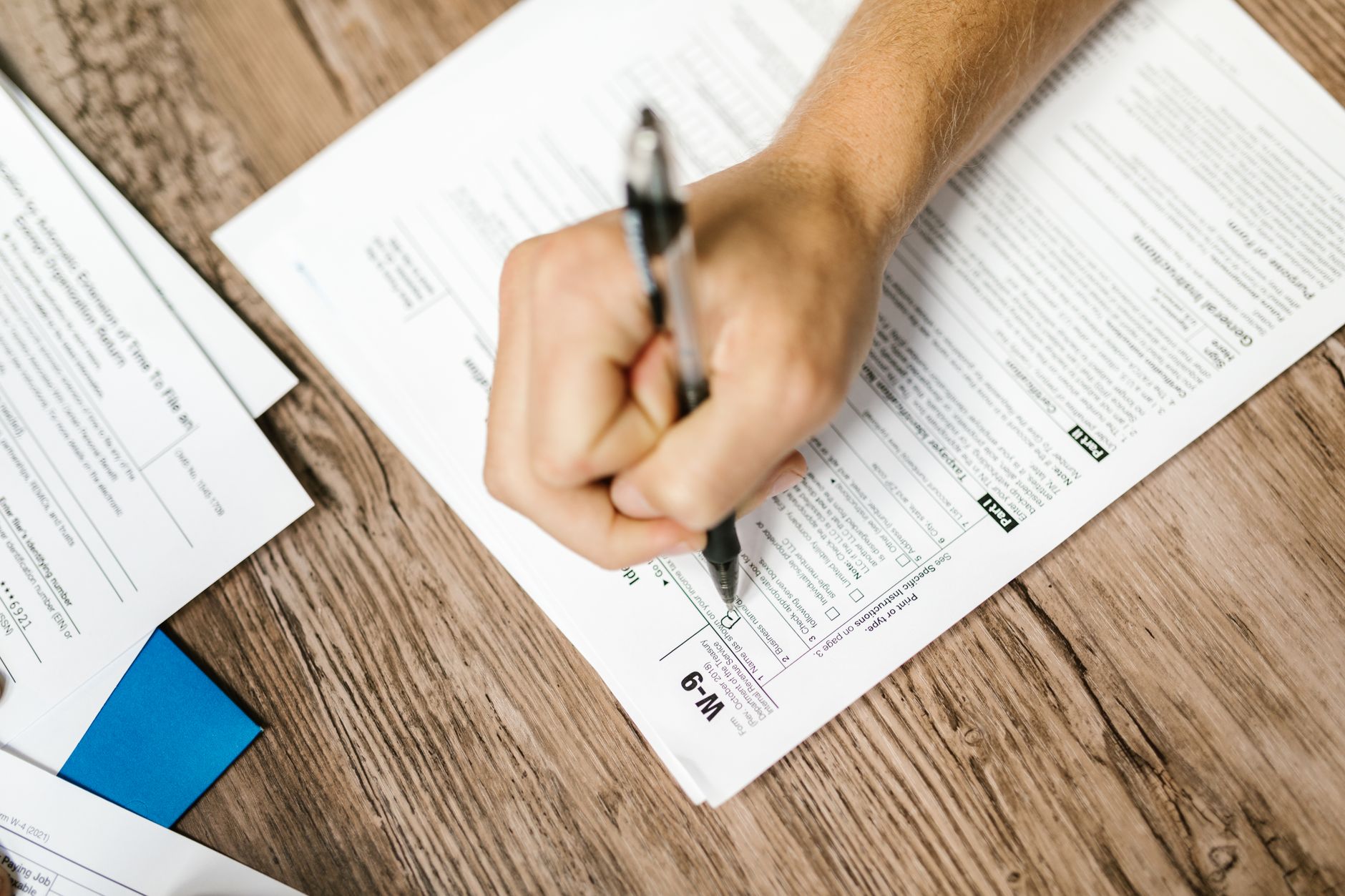 A person reviewing government tax paperwork at a table