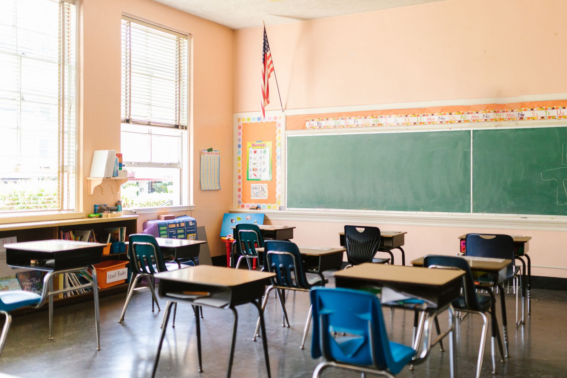 Empty school classroom with vacant desks and chairs