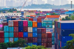 Aerial view of a busy shipping port with stacked cargo containers