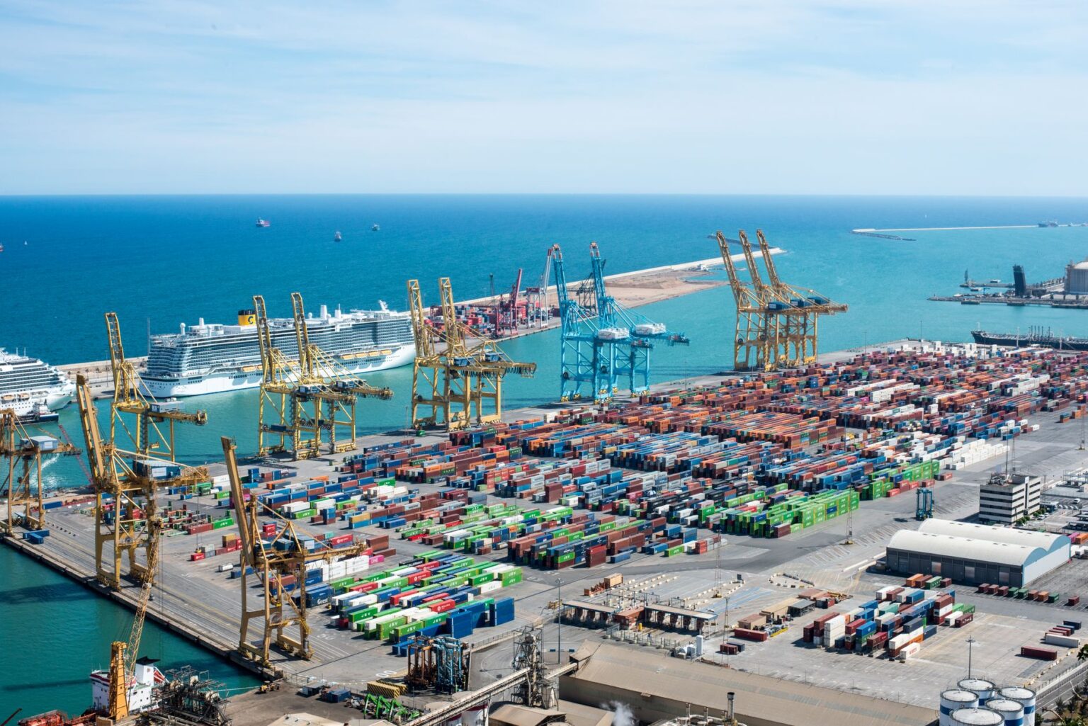 Longshoremen Pension Costs Quietly Sink Small Port Authorities Aerial view of a small regional cargo port with shipping containers and cranes