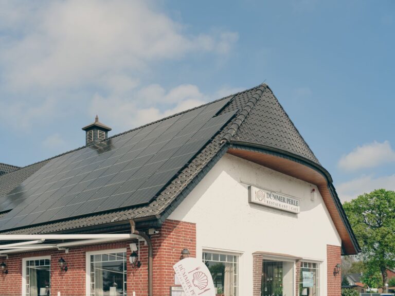 Residential solar panels installed on a rooftop under clear sky