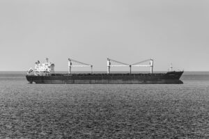 Large cargo container ship sailing through open ocean waters