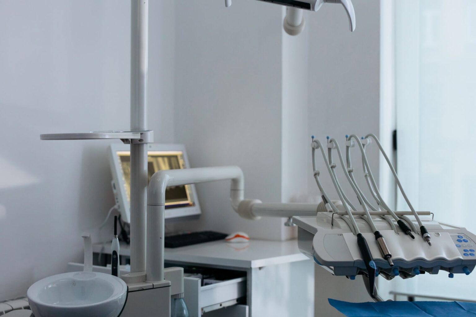 Dental Practice Consolidation Leaves Rural Patients With Fewer Options Empty dental examination room with chair and equipment in a small clinic