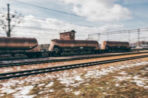 Rail Freight Volume Slump Signals Deeper Industrial Demand Weakness A long freight train traveling through an industrial landscape, representing rail cargo volume trends