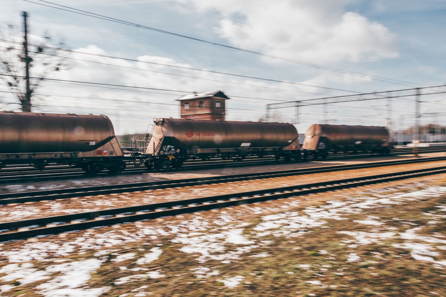A long freight train traveling through an industrial landscape, representing rail cargo volume trends
