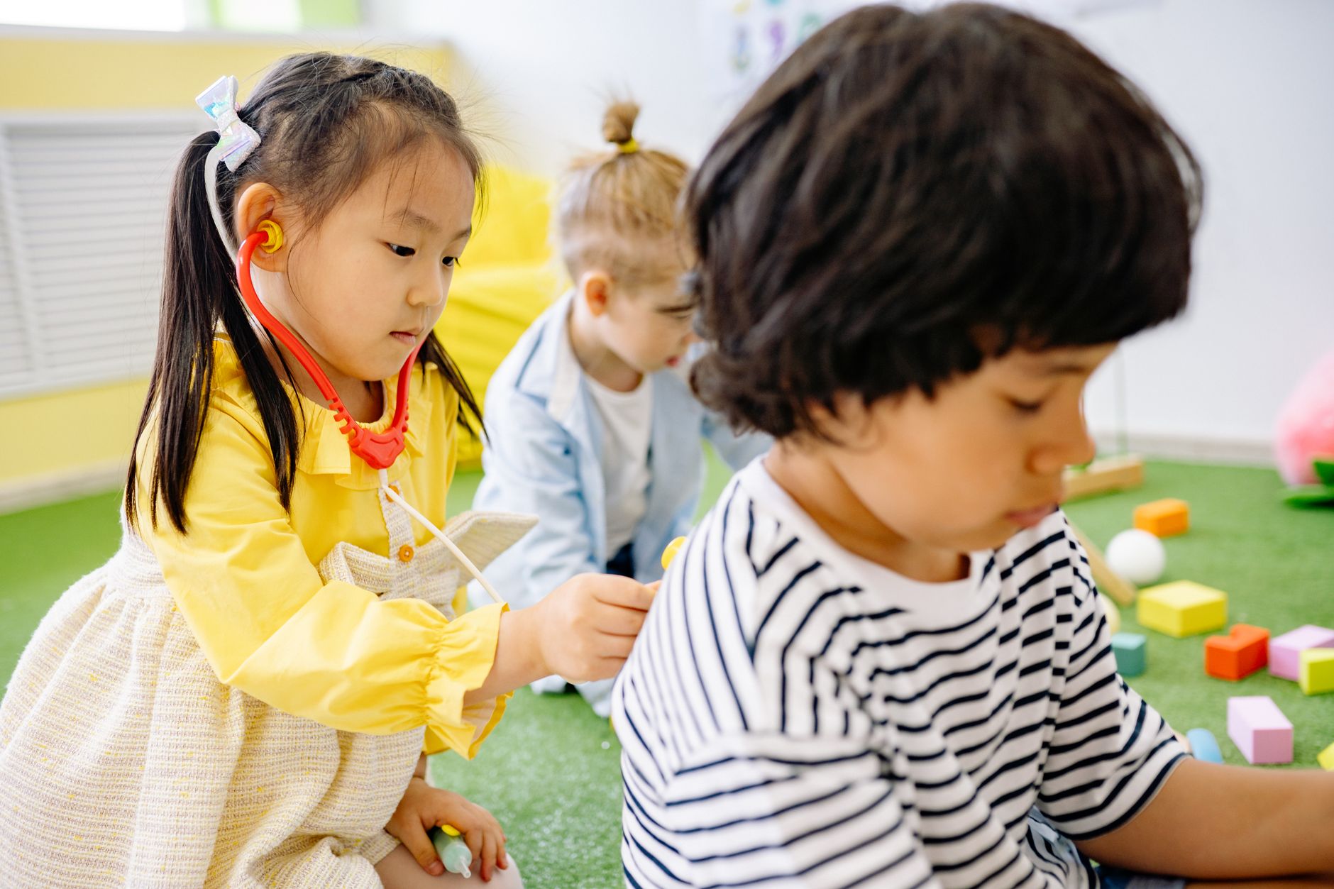 Young children sitting together inside a licensed daycare center classroom