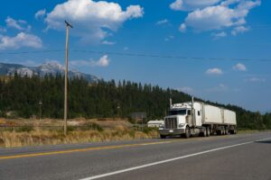 Freight Broker Margins Collapse as Shipper Direct Contracts Expand Semi truck driving on a highway representing freight transportation industry