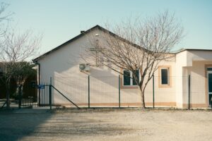 Small rural health clinic building with parking lot in a countryside setting
