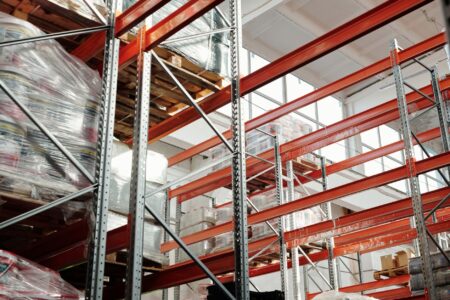 Large empty warehouse interior with high ceilings and vacant storage space