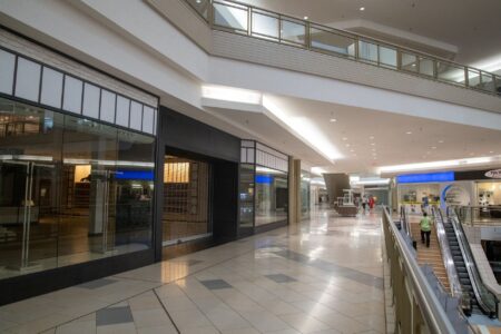Retail Foot Traffic Slump Deepens as Consumer Confidence Cracks Empty shopping mall corridor with few shoppers and vacant storefronts