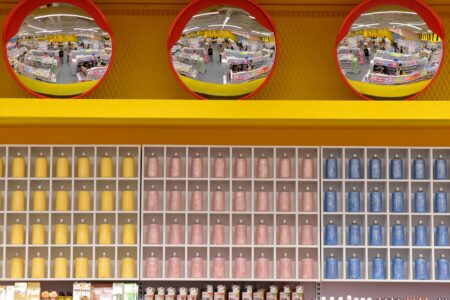 Wide aisle inside a warehouse club store stocked with bulk goods and pallets