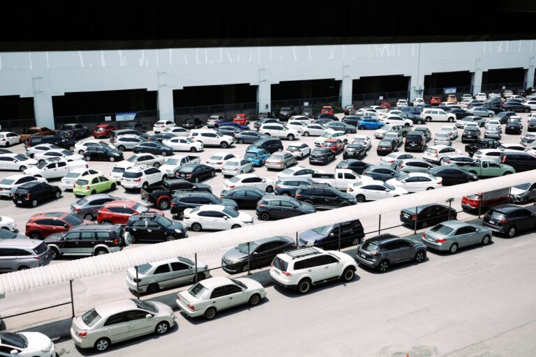 Used Car Loan Defaults Climb as Negative Equity Traps Spread Rows of used cars on a dealership lot under overcast skies