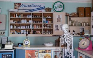 Empty retail pharmacy shelves and closed counter in an urban neighborhood