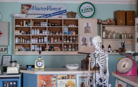 Empty retail pharmacy shelves and closed counter in an urban neighborhood