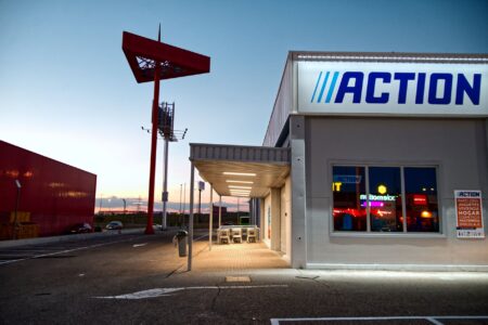 Empty strip mall storefronts with vacant retail spaces and a mostly empty parking lot