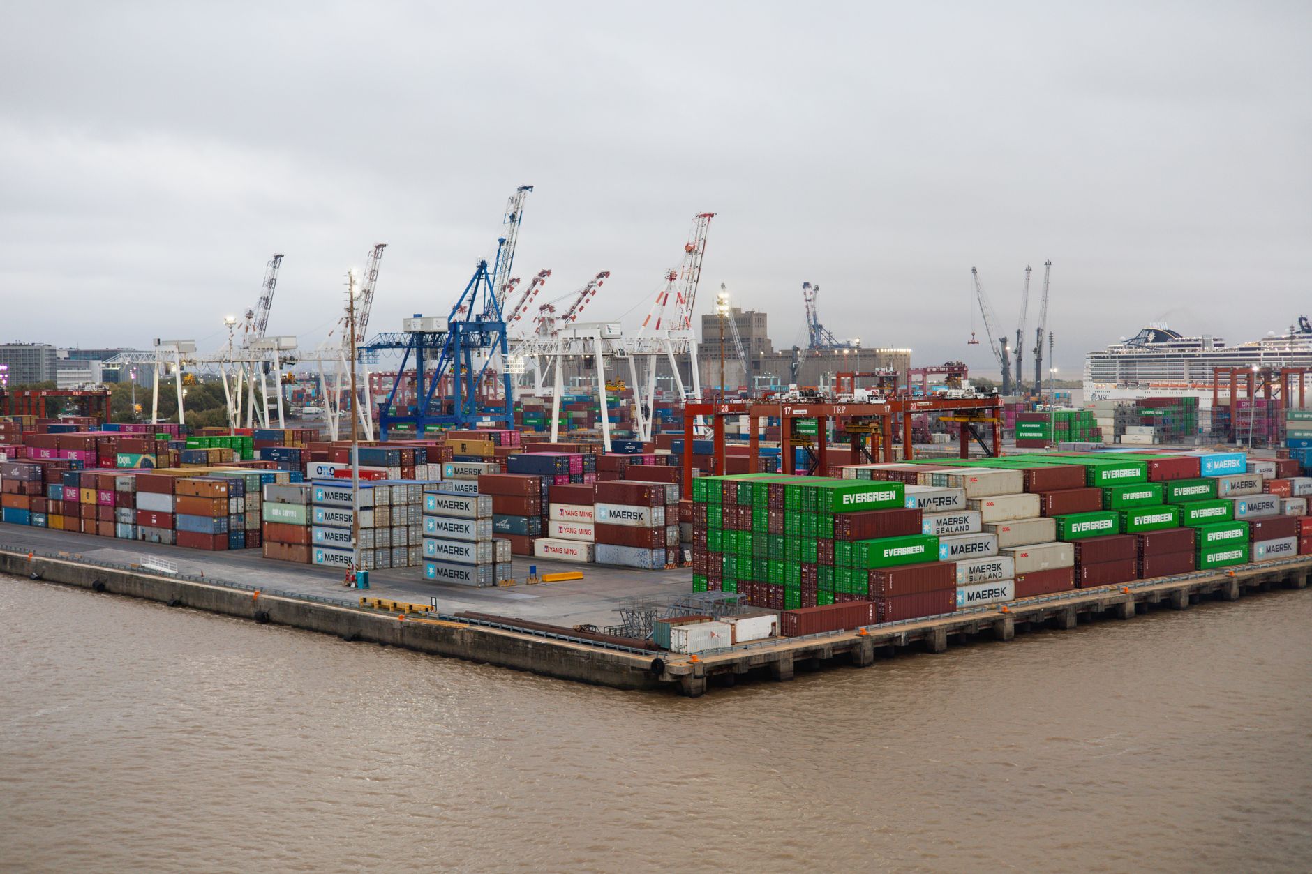 Rows of stacked shipping containers at an industrial port terminal